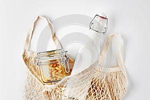 Zero waste, plastic-free and eco-friendly lifestyle. Cotton mesh bag, glass bottle and jar with bulk food
