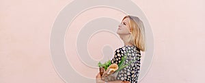 Zero waste. Portrait of Young woman in summer dress with a paper craft eco bag of vegetables and baguette. Sustainable