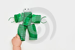 Zero waste, the second life of things. Toy robot made of plastic caps on a white background. faceless. Recycling art