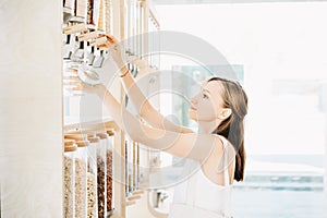 Zero waste shop. Girl buying in sustainable plastic free grocery store