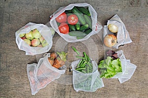 Zero waste shopping concept. No single-use plastic. Fresh organic vegetables, fruits and greens in reusable recycled mesh produce