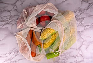 Zero waste shopping concept. Vegetables in eco-cotton bags on the table. Plastic rejection concept.