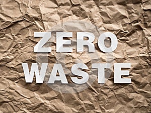 Zero waste white text on brown crumpled craft paper background. Eco waste recycling concept