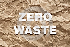 Zero waste white text on brown crumpled craft paper background. Eco waste recycling concept
