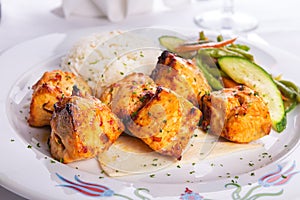 Zesty Chicken Shish Kebabs served on a Lavash Bread with rice Pi