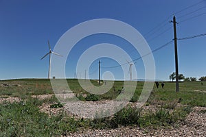 Zhambyl region, Kazakhstan - 05.15.2013 : Old power lines line the new wind turbines