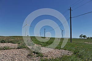 Zhambyl region, Kazakhstan - 05.15.2013 : Old power lines line the new wind turbines