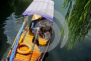 ZHOUZHUANG, CHINA:  Helmsman driving the boat passing through canals