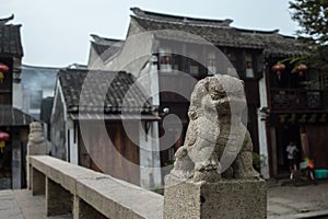 ZHOUZHUANG, CHINA: Old houses and bridge reflection in a village canal