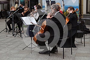 Zhytomyr, Ukraine - May 15, 2021: man street musician playing cello classical music