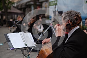 Zhytomyr, Ukraine - May 15, 2021: man street musician playing cello classical music