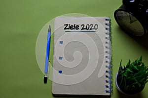 Ziele 2020 write on a book isolated on office desk. German Language it means Goals