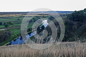 Zigzag river flows between summer valleys