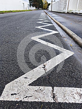 Zigzag road marking on asphalt, a visual guide for drivers