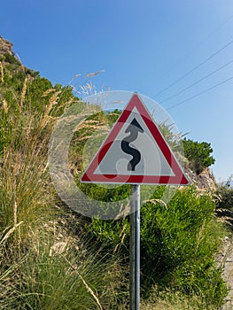 Zigzag road warning sign board