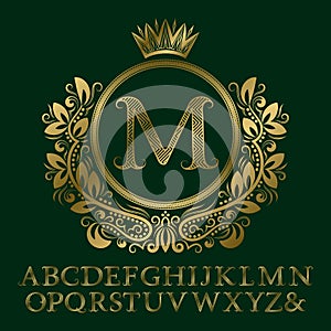 Zigzag striped gold letters and initial monogram in coat of arms form with crown. Elegant font and elements kit for logo