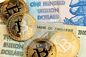Zimbabwe hyperinflation banknotes and  Bitcoin Cryptocurrency coins photo