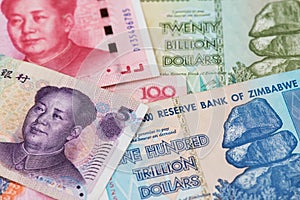 Zimbabwe hyperinflation Dollar and China Yuan Renminbi currency banknotes. photo