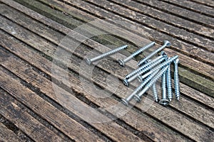 Zinc plated screws on top of old reclaimed wood