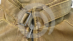 Zipper on the brown leather jacket unfolds.