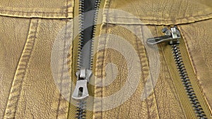 Zipper on the brown leather jacket unfolds.