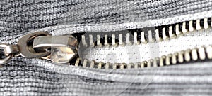 Zipper on gray denim close-up, wide view. Flat lay, top view, copy space