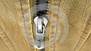 The zipper opens on the brown leather jacket.