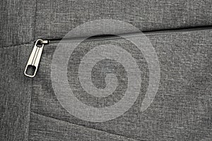 Zipper pocket of grey textured fabric background