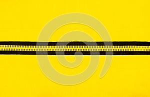 Zipper on the yellow cloth background