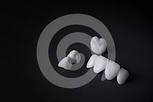 Zircon dentures on a black background - Ceramic veneers - lumineers photo