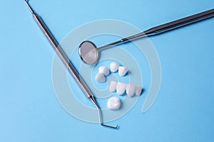 Zircon dentures , dental tools on a blue sheet - Ceramic veneers - lumineers