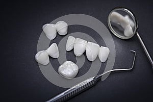 Zircon dentures and Dental tools on a dark background - Ceramic veneers - lumineers