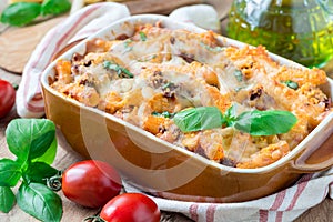 Ziti bolognese in baking dish. Pasta casserole with minced meat, tomato sauce and cheese, horizontal