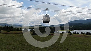 Zlatibor Gold Gondola Lift Cabin on Cables. Aerial View of Cablecar Under Sky