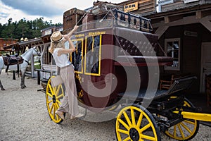 Embrace the Wild West: Woman on a Cowboy Wooden Wagon in El Paso