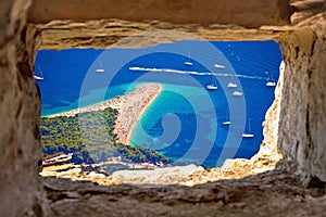 Zlatni rat beach aerial view through stone window