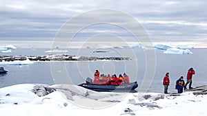 Zodiac approaching snow covered slopes in Antarctica