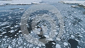 Zodiac boat float in melting brash ice aerial view photo
