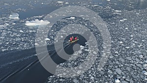 Zodiac motor boat sailing in Antarctic ice. Aerial Tracking