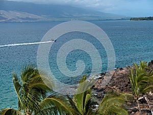 Zodiak speed boat leaving long wake