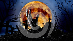 Zombie hand comes out of the grave and bats fly. Graveyard background