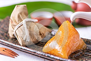 Zongzi - Alkaline rice dumpling - Traditional sweet Chinese crystal food on a plate to eat for Dragon Boat Duanwu Festival
