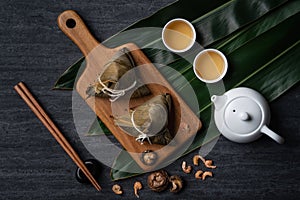 Zongzi. Rice dumpling top view for Dragon Boat Festival over dark black background