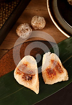 zongzi, rice dumplings,Made with glutinous rice and meat or egg yolk, wrapped in zong leaves