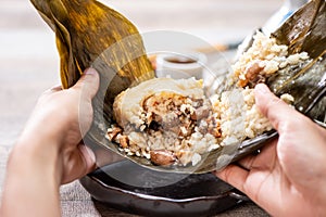 Zongzirice dumpling with a cup of tea on a wood table, Dragon Boat Festival, Asian traditional food