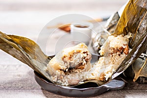 Zongzirice dumpling with a cup of tea on a wood table, Dragon Boat Festival, Asian traditional food