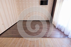 Zoning floor in interior, ceramic tile smoothly into the living room laminate photo