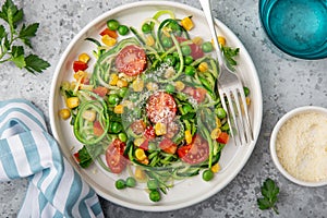 Zoodle zucchini noodle  with vegetables on white plate