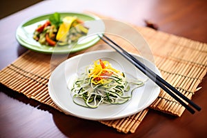zoodles on a bamboo mat with chopsticks