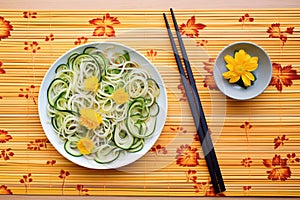 zoodles on a bamboo mat with chopsticks